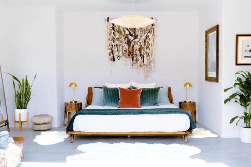 a bedroom with a bed with orange and green pillows at Peaceful Desert Paradise - Casa Coyote in Joshua Tree