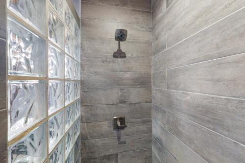 a bathroom with a stone wall at Suite 1 at Island Pearl Gold Standard Certified in Caye Caulker