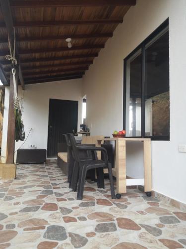 a dining room with a table and some chairs at Villa Namaste - Cabaña Albores in Curití