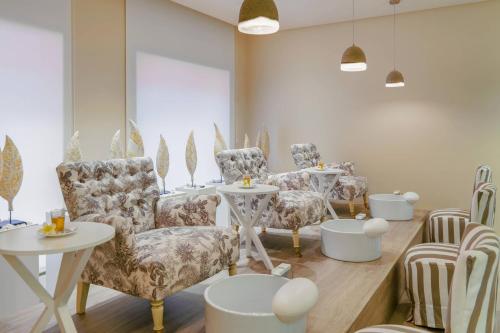 a room with a bunch of chairs and tables at The Ritz-Carlton Tenerife, Abama in Guía de Isora