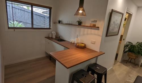 a kitchen with a counter and a sink in a room at 'Stay in Carrara' A private guest suite not a share house in Gold Coast