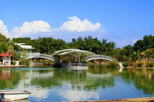 a bridge over a pond in a park at AM.AIRBNB in Santo Domingo