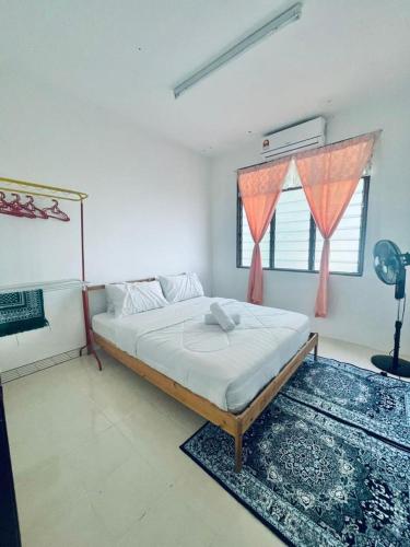 a bedroom with a bed and a large window at Ast kok Lanas homestay in Ketereh