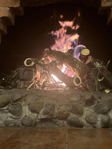 a fire in a stone oven at night at Finca Campestre La Adelita B&B in Salento