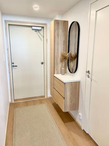 a bathroom with a shower and a sink and a mirror at Marina Sunset Resort A2 in Kalajoki