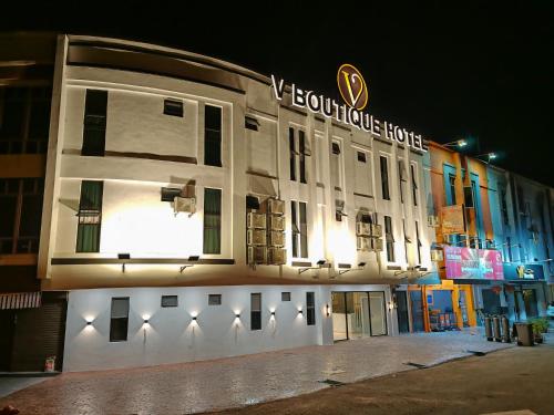 a building with a sign on the side of it at V Boutique Hotel Seremban in Seremban