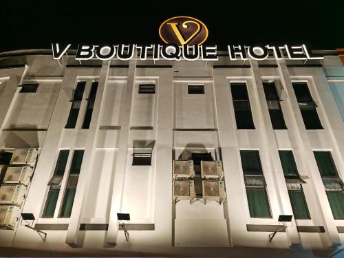 a building with a hotel sign on the side of it at V Boutique Hotel Seremban in Seremban