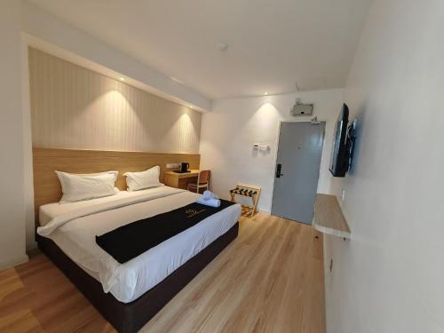 a hotel room with a bed and a television at V Boutique Hotel Seremban in Seremban