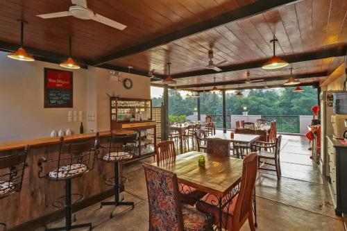 a restaurant with tables and chairs and a bar at Casa Marina Bed and Breakfast in Pagsanjan