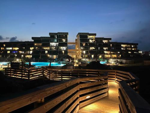 a view of a city at night with buildings at Mayan Princess 101 Beachfront Resort in Port Aransas
