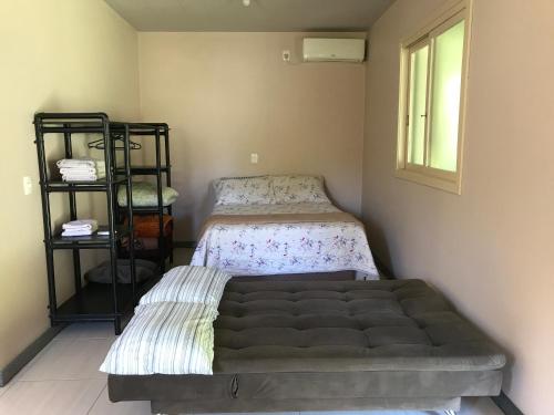 מיטה או מיטות בחדר ב-Casa no Vale dos Vinhedos