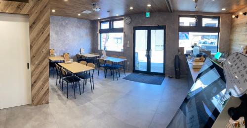 a restaurant with tables and chairs in a room at The Toya in Lake Toya
