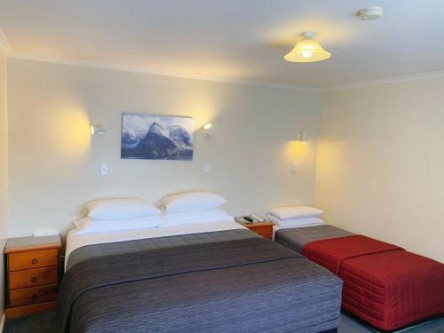 a hotel room with two beds in a room at Amber Court Motel in Te Anau