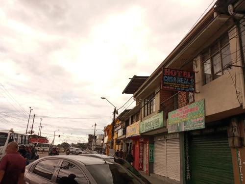 a street with a car parked in front of buildings at Hotel Casa Real 2 in Popayan