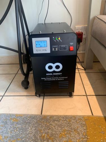 a machine is sitting on the floor next to a couch at The Tipsy Expat in Paarl