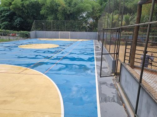 a basketball court with blue paint on it at Flat 902 Golden Dolphin Express in Caldas Novas