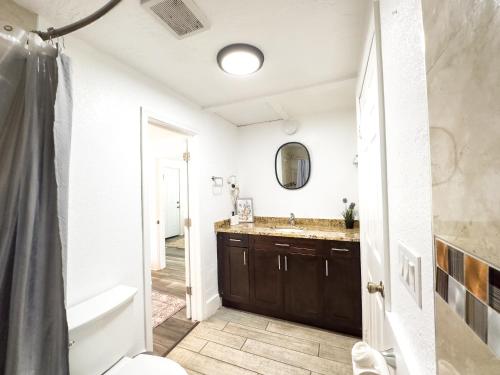 a bathroom with a sink and a toilet and a tub at 2b1b Stylish Little House W Shared Pool 511 in Clearwater