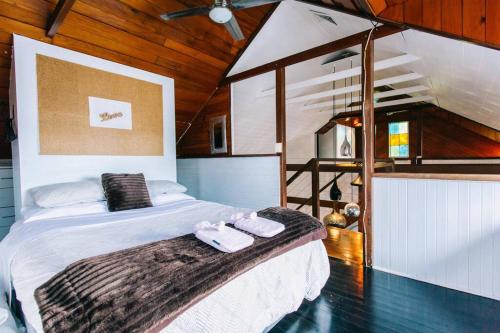 a bedroom with a bed with two towels on it at BELLINGEN CONVERTED CHURCH on the river (Pet Friendly) in Bellingen