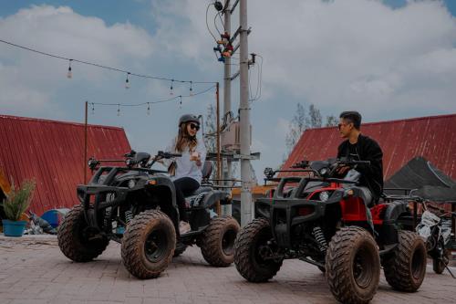 a man and a woman sitting on four wheelers at Hotel Nature Bromo and Resort in Pasuruan