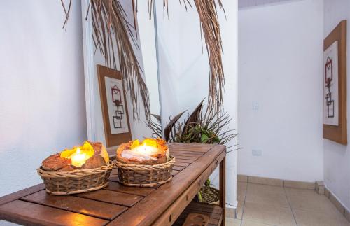 two baskets of bread sitting on a wooden table at Pousada Castelinho in São Sebastião