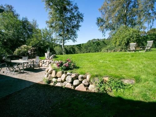 a garden with a table and chairs in a field at 7 person holiday home in Tranekær-By Traum in Tranekær