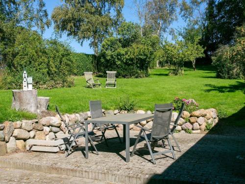 a picnic table and chairs in a park at 7 person holiday home in Tranekær-By Traum in Tranekær