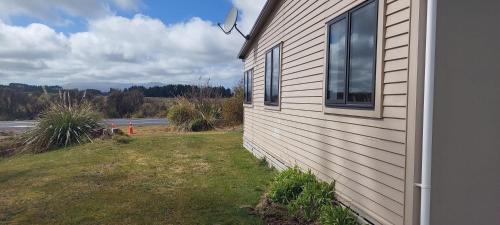 a building with a window on the side of it at Tongariro Estate in National Park