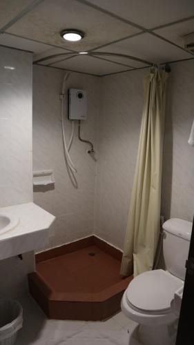 a bathroom with a toilet and a sink and a shower at Patong Triple P in Patong Beach