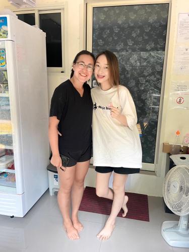 two women posing for a picture in front of a refrigerator at Magic Hostel in Phi Phi Don