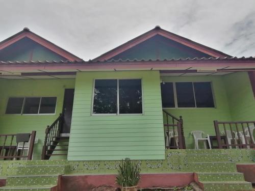 a green house with a porch at Phi Phi View Point Resort in Phi Phi Don