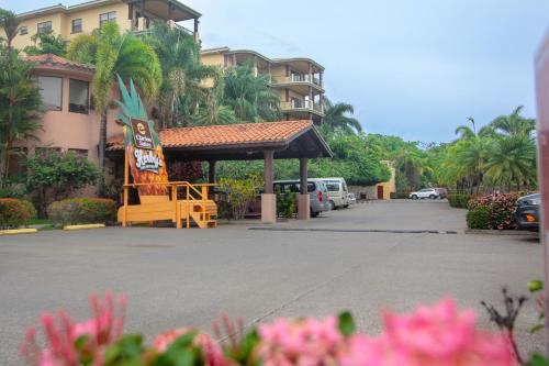 a gas station with a sign in a parking lot at Pineapple Villa 442 condo in Roatan