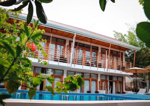 a building with a swimming pool in front of it at Ananda Resort in Panglao