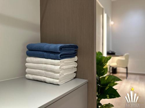 a stack of towels on a shelf in a room at Bali Residences Melaka by Lá VISTA in Melaka