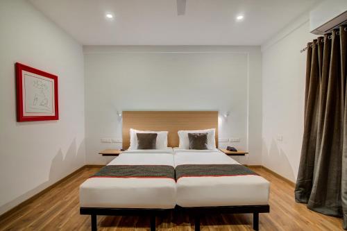 a bedroom with a large white bed in a room at OYO Townhouse 078 DODDA BANASWADI in Bangalore