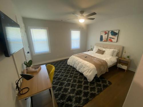 a bedroom with a bed and a ceiling fan at East Point Atlanta - Spacious 5BR Retreat! in Atlanta