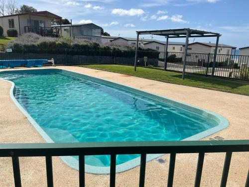 a swimming pool with a gazebo in a yard at Anlyn seaside cabin in Apollo Bay