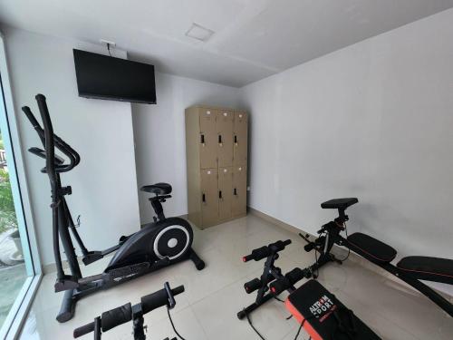 a room with two exercise bikes and a flat screen tv at LHC HOTEL AND RESORT in Pattaya Central