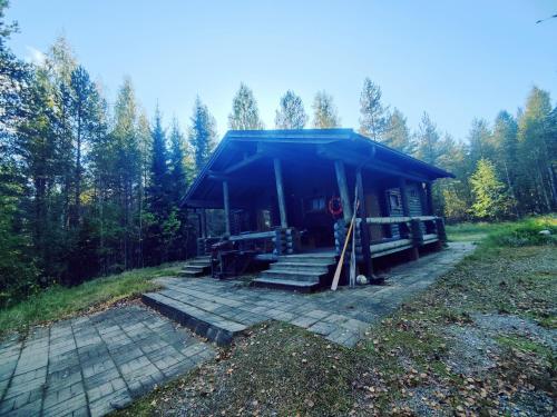 une petite cabine avec un toit bleu dans les bois dans l'établissement Kalliorinteen Mökit Suvipirtti, à Töysä
