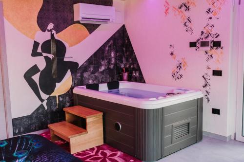 a bathroom with a tub with a guitar on the wall at Bed & Breakfast dei sogni in Ascoli Piceno