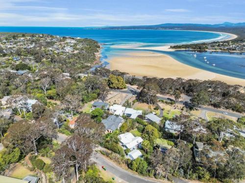 an aerial view of a beach with houses and the ocean at Blue on Collins in Merimbula