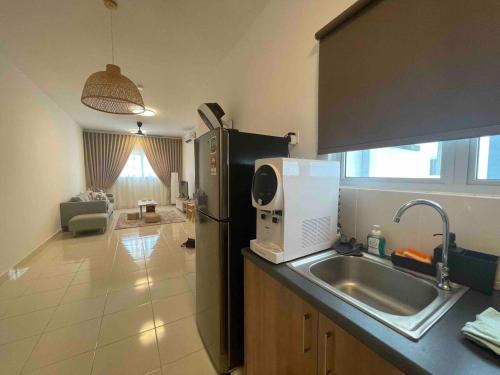 a kitchen with a sink and a refrigerator at Alanis B1405 in Sepang