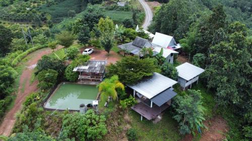 an aerial view of a house with a swimming pool at Monsonkeang Camping view ม่อนสันเกี๋ยง in Mae Chaem