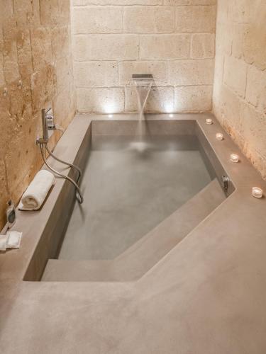 a bath tub in a bathroom with a tub at Hydria Rooms in Matera