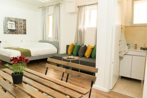 a small room with a bed and a couch at kotel apartment in Jerusalem