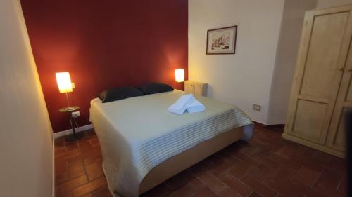 um quarto com uma cama com 2 candeeiros e uma porta em Numero 6 em Todi