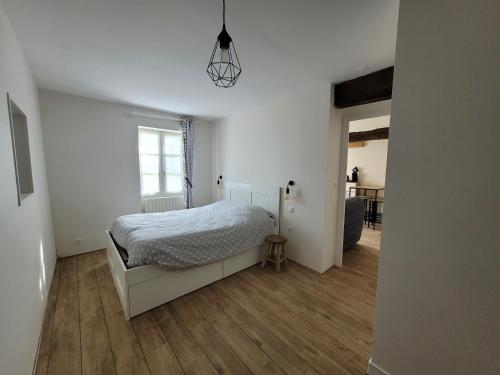 une chambre blanche avec un lit et une fenêtre dans l'établissement Chambre indépendante privée, à Cheverny