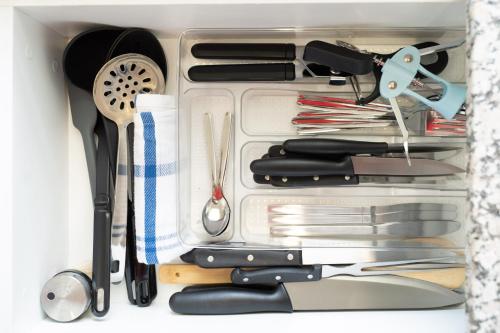 a drawer filled with cooking utensils and spatulas at Hampton Collection - 2 Sleeper Studio Apartment with Pool in Durban