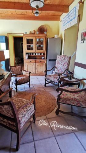 a living room with several chairs and a table at Mes Maisons Gardoises, Two Gites sleeping 13 with Two Private pools, Kids Room, Laundry, Disco, free WiFi, Linen and Dog's are Welcome in Gagnières