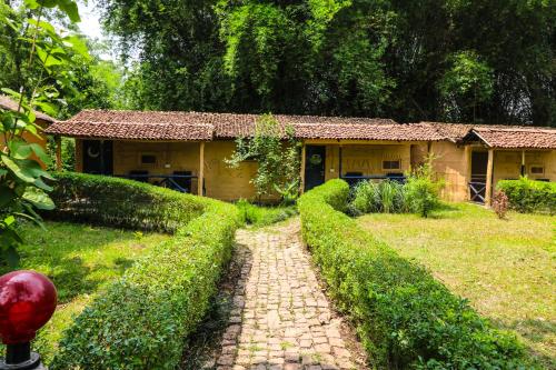 uma casa com um caminho em frente a um quintal em Wild Planet Eco Retreat em Bhurkīā