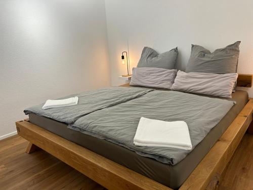 a large bed with two pillows on top of it at Haus 11 in Oberkirch